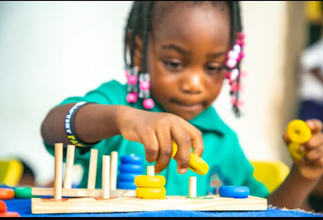 Nursery pupils engaged in a hands-on learning activity at Ambassadors Bilingual School
