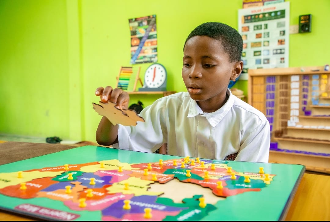 Pupils exploring a science demonstration in the classroom at Ambassadors Bilingual School