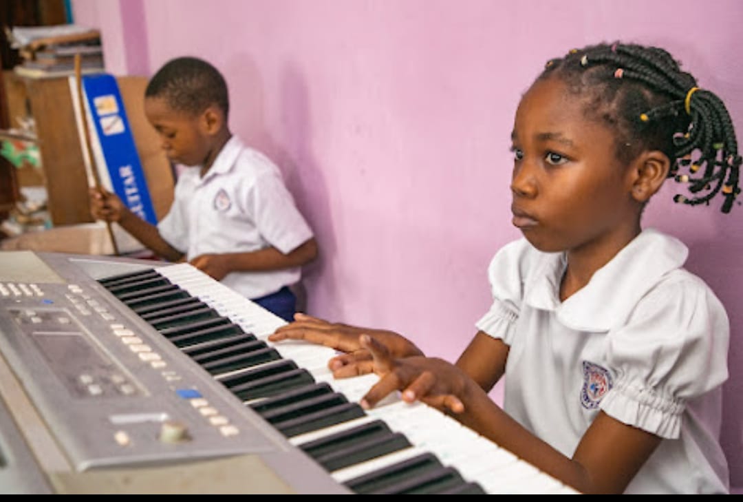 Pupils smiling in class at Ambassadors Bilingual School, College Road, Lagos